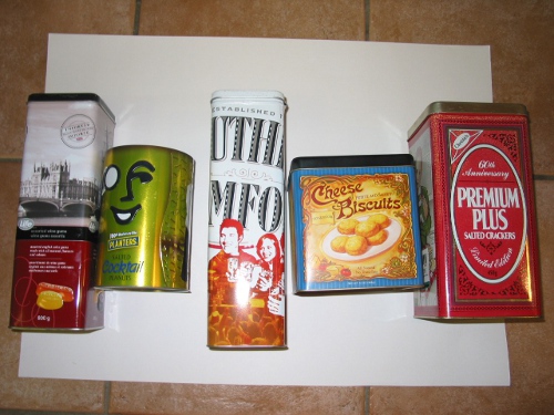 assorted collection of advertising cans